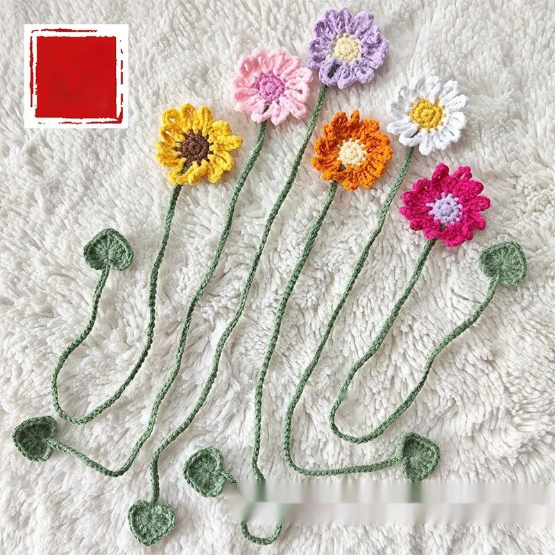 Hand-crocheted daisy flexible wire bookmark in yellow, pink, light purple, and orange colours.