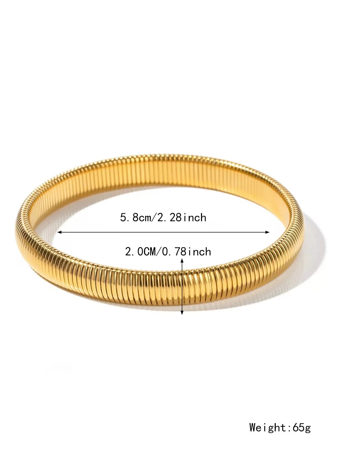 Close-up of a women's elastic titanium steel bracelet featuring a bold vertical stripe ring pattern in a gold tone finish.