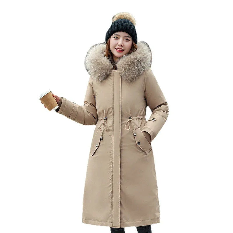 Women's long beige fleece trench coat with a belt, shown on a model.