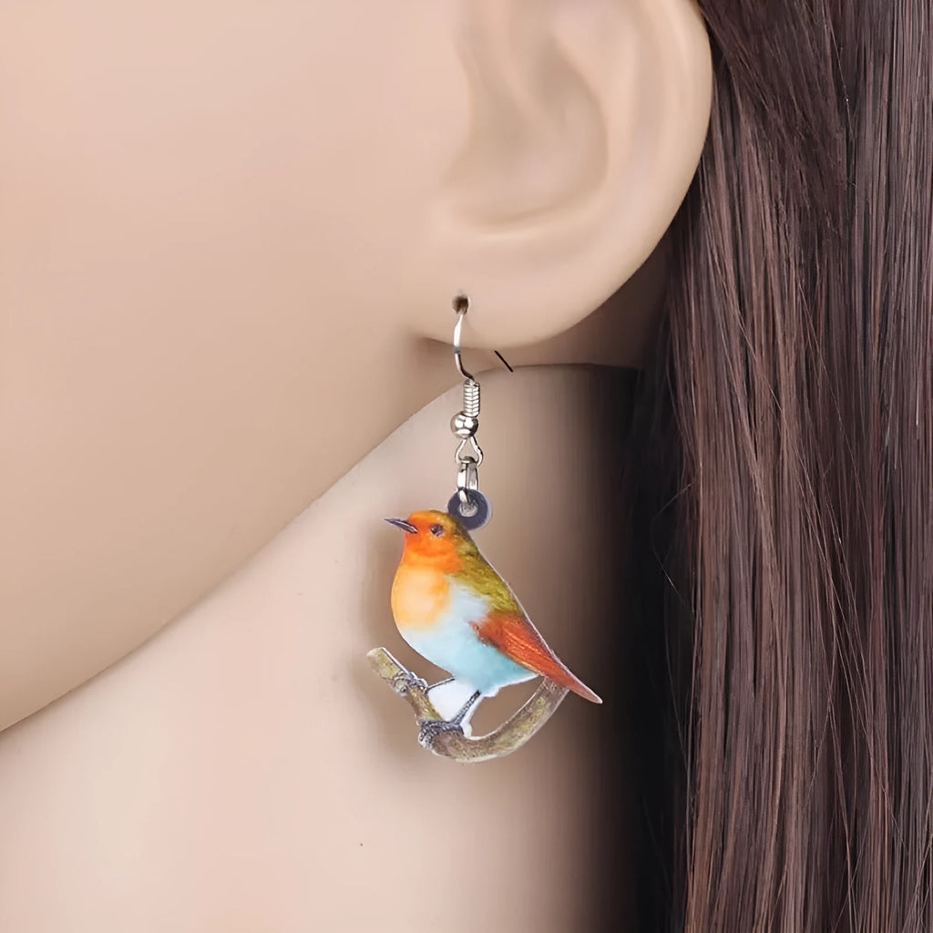 Blue Titmouse bird pendant acrylic earrings with geometric shapes and snake zodiac motifs.
