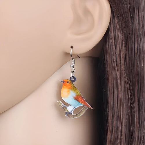 Blue Titmouse bird pendant acrylic earrings with geometric shapes and snake zodiac motifs.