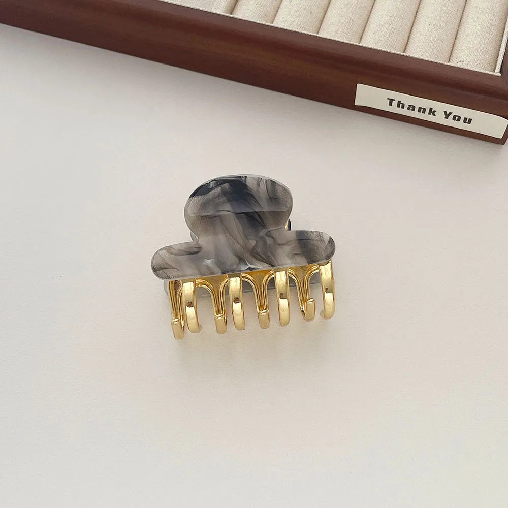 Set of four retro acetate hair barrettes with metal grip in beige, white, dark, and leopard print designs