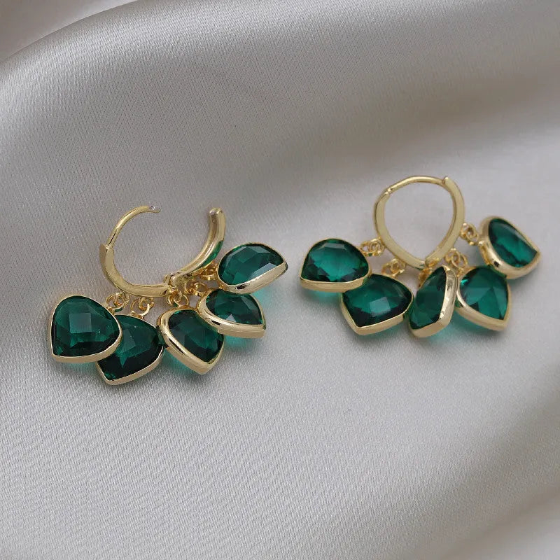 Korean style women's green heart ear clip earrings with alloy inlay gemstone.