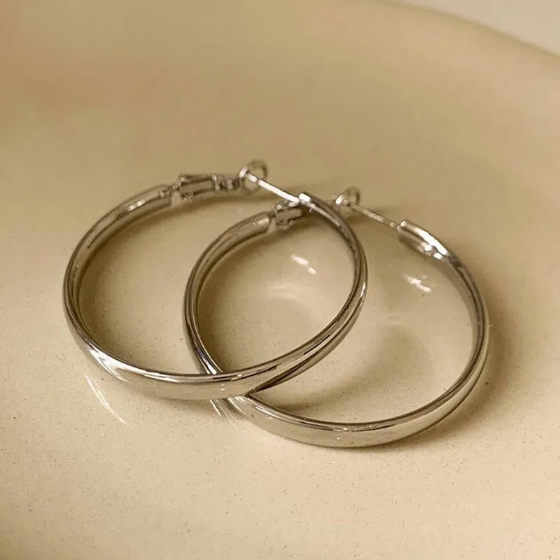 40mm diameter gold and silver metal circle earrings on display