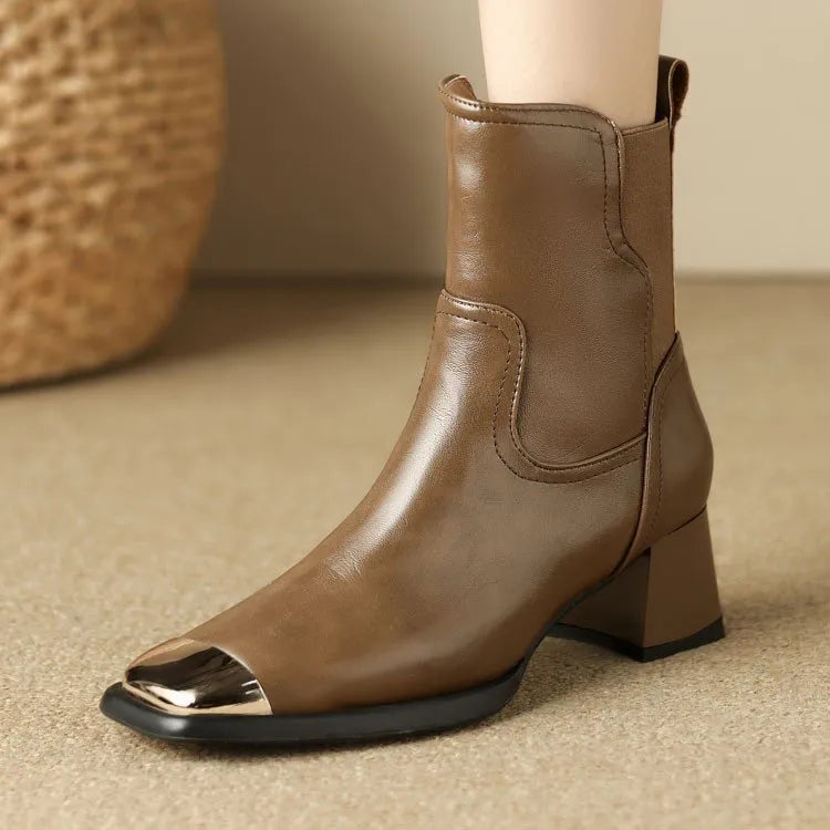 Brown women's Martin boots with side zipper and decorative metal details on a rubber sole.