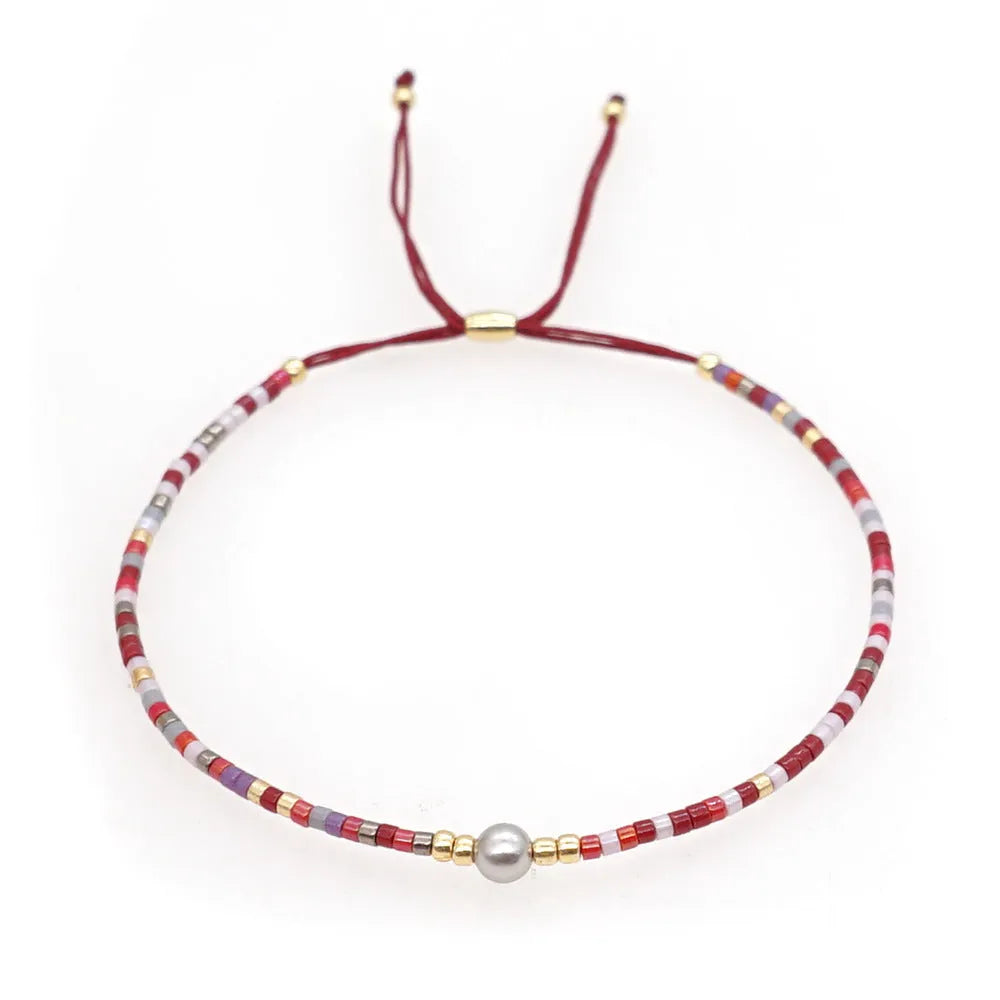 Women's handmade colourful beaded bracelet with geometric glass beads on adjustable cord