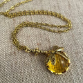 Vintage bronze hand carved dragonfly pendant on a silver chain, yellow colour
