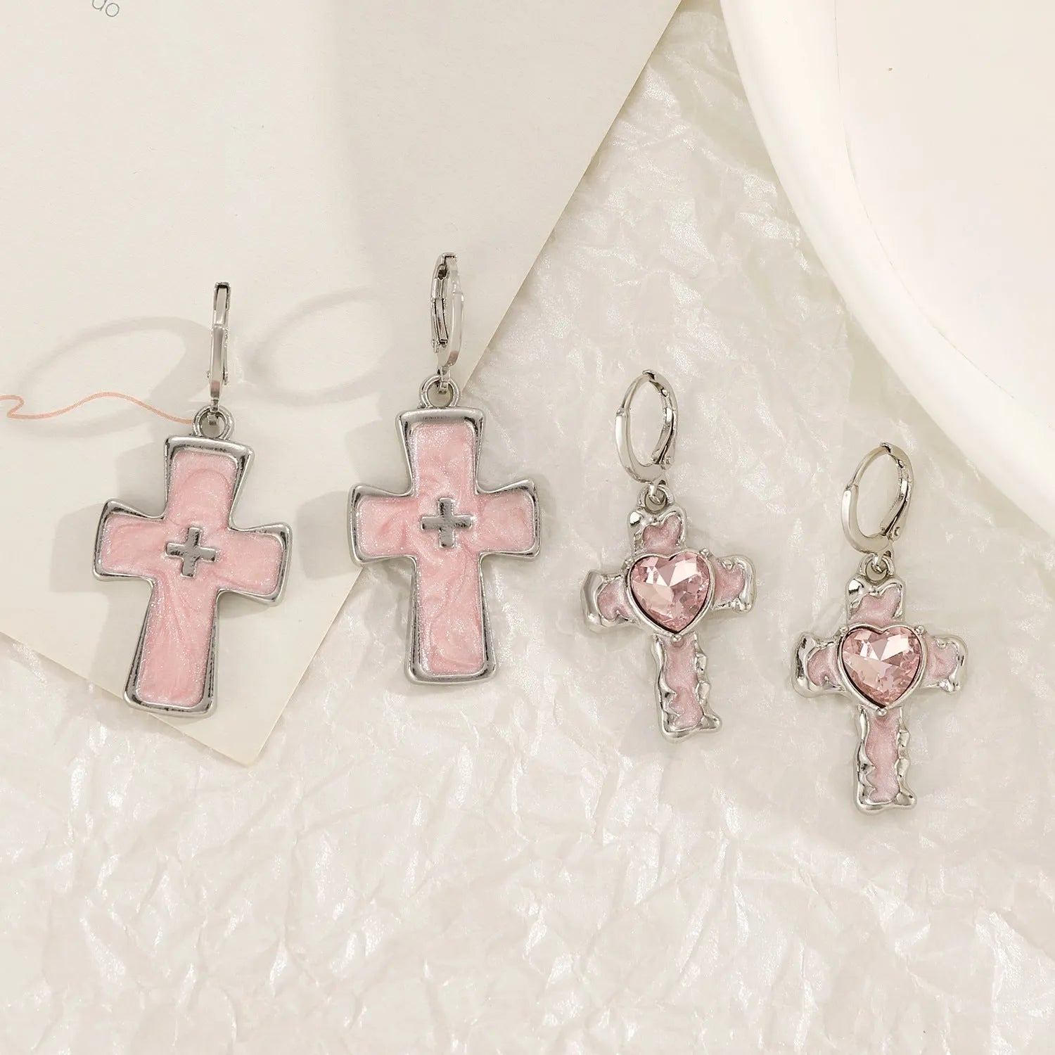 Women's alloy cross crystal earrings in five designs: white cross, peach heart, black cat, antique silver star.