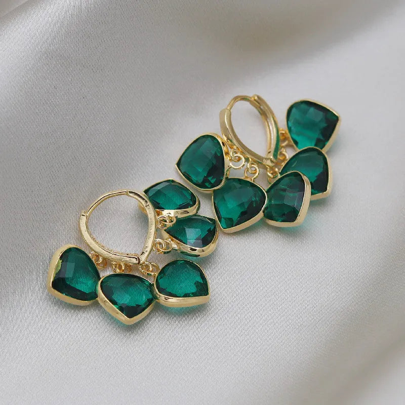 Korean style women's green heart ear clip earrings with alloy inlay gemstone.