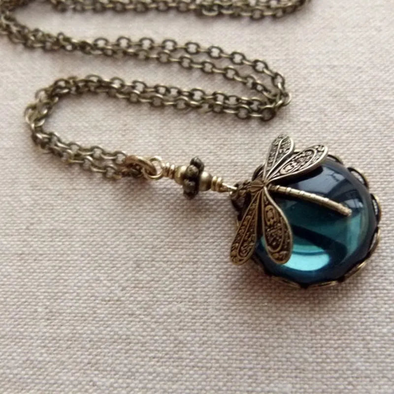 Vintage bronze hand carved dragonfly pendant on a silver chain, yellow colour