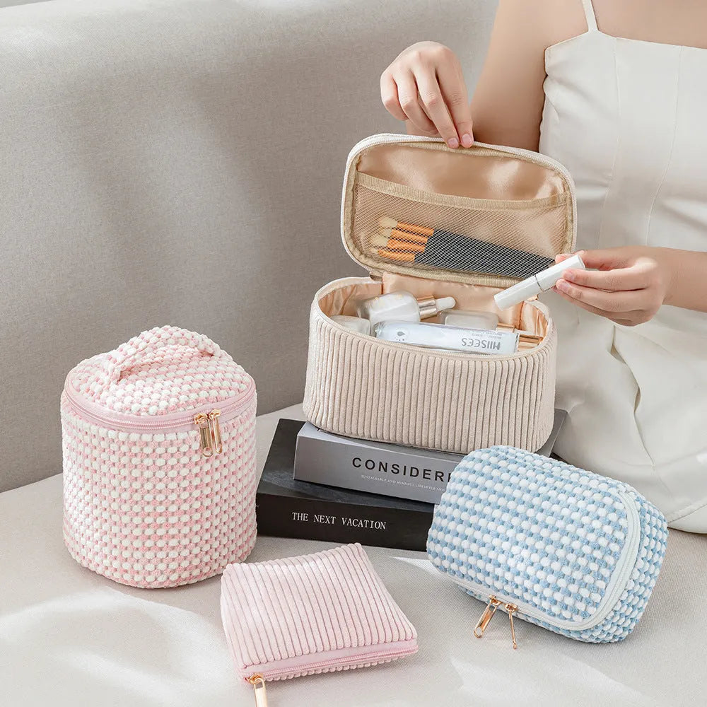 Four cube-style makeup bags in polyester material showing colour options: pink, khaki, pink dots, blue with dots