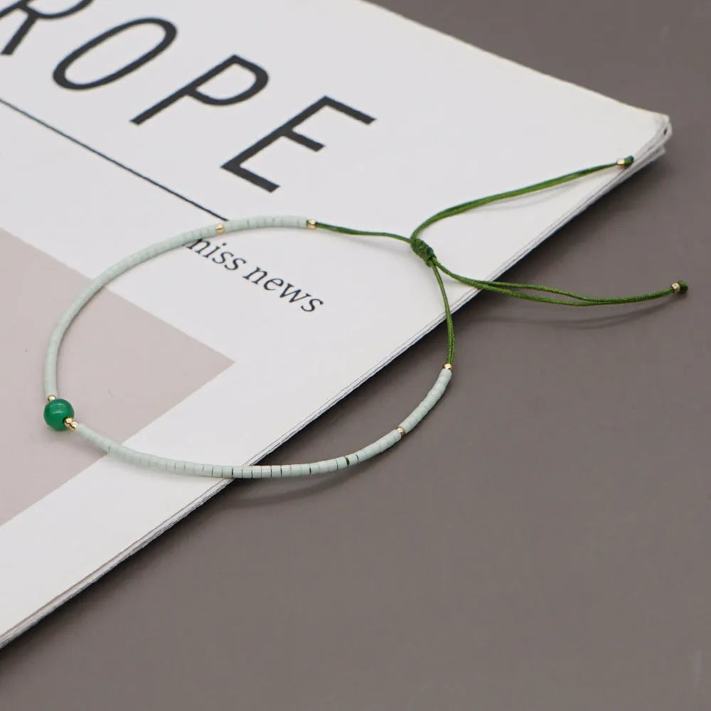 Women's handmade colourful beaded bracelet with geometric glass beads on adjustable cord