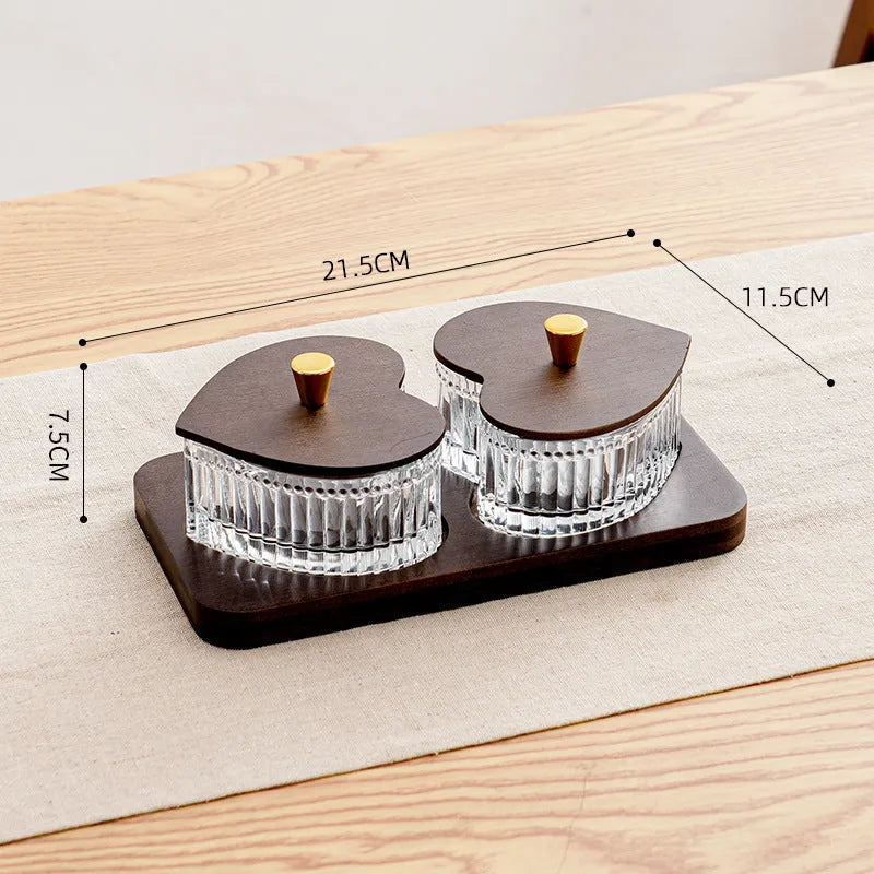 Glass retro-style snack platter with coloured glaze and a transparent heart-shaped lid over multiple compartments.