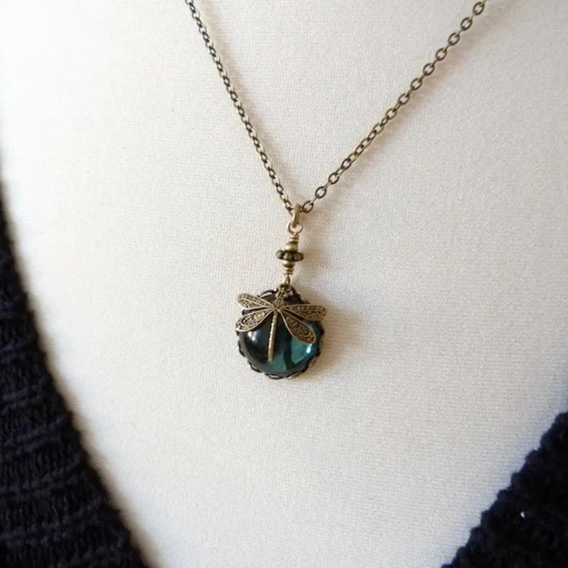Vintage bronze hand carved dragonfly pendant on a silver chain, yellow colour