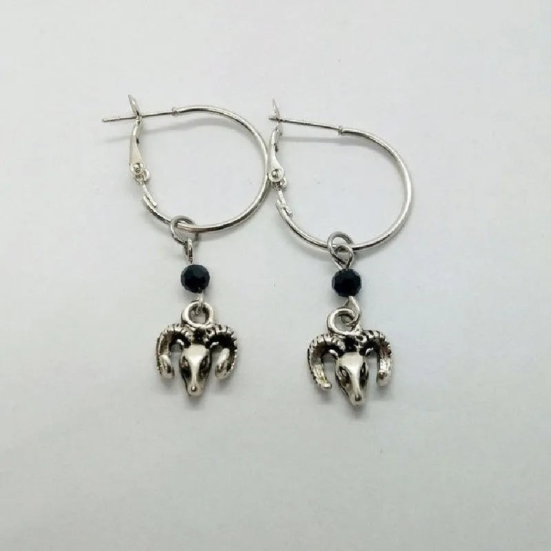 Silver-coloured round ring earrings for women featuring a raised Tibetan antelope design on an alloy metal hoop.