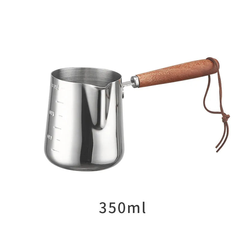 Stainless steel milk frothing jug with volume scale and wooden handle in three size options.