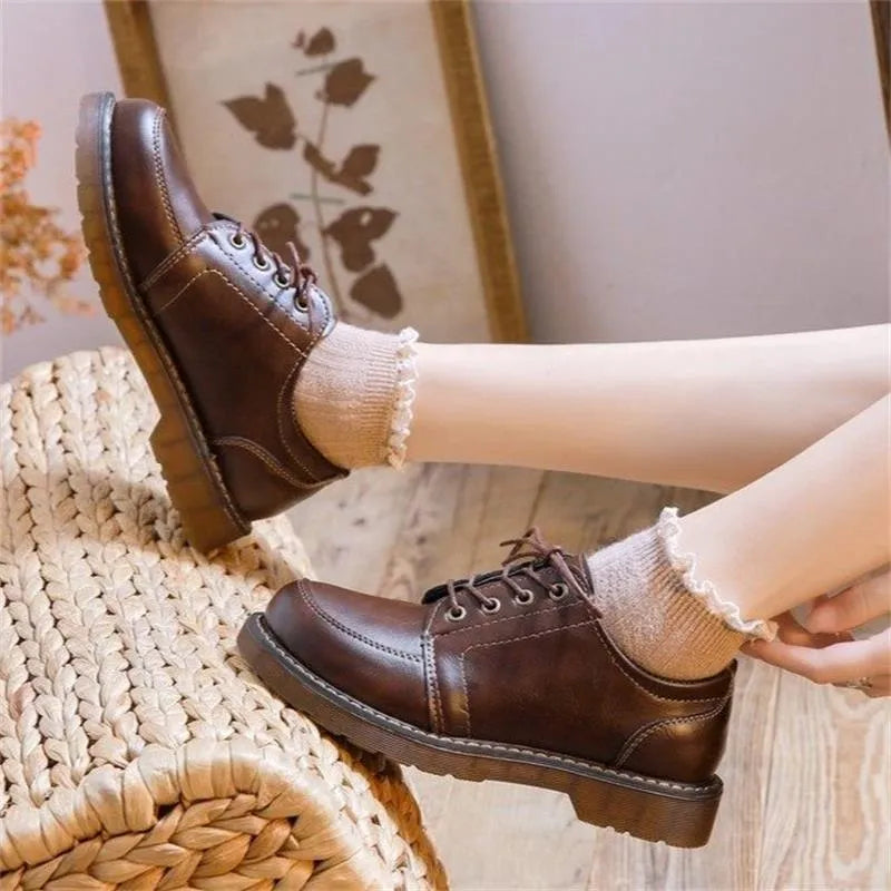 Black retro women's Mary Jane shoes with front lace-up and low square heel.