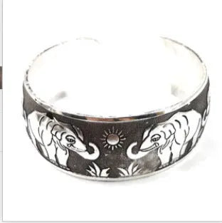 Openwork Miao ethnic carved silver bracelet with elephant or turtle motifs