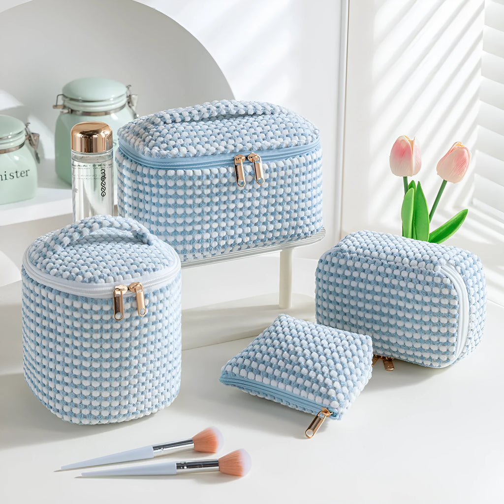 Four cube-style makeup bags in polyester material showing colour options: pink, khaki, pink dots, blue with dots