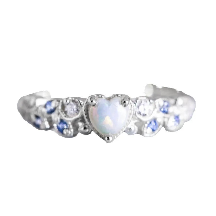 Peach-coloured women's heart-shaped ring with a detailed flower opal ocean design on its surface.
