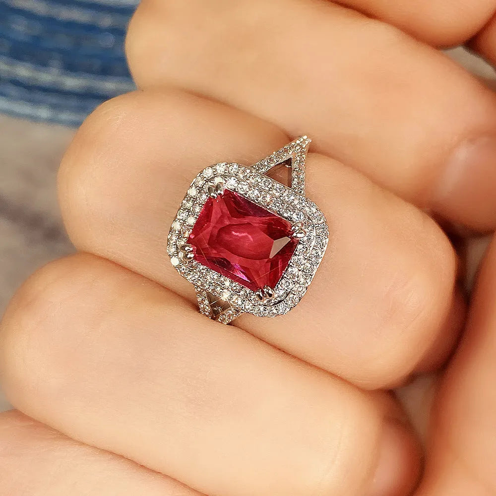 Copper square princess ring with red rhinestones on a geometric band.