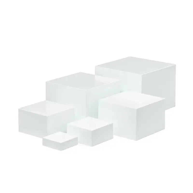 Set of six white geometric plastic cubes arranged as a tiered dessert display stand.