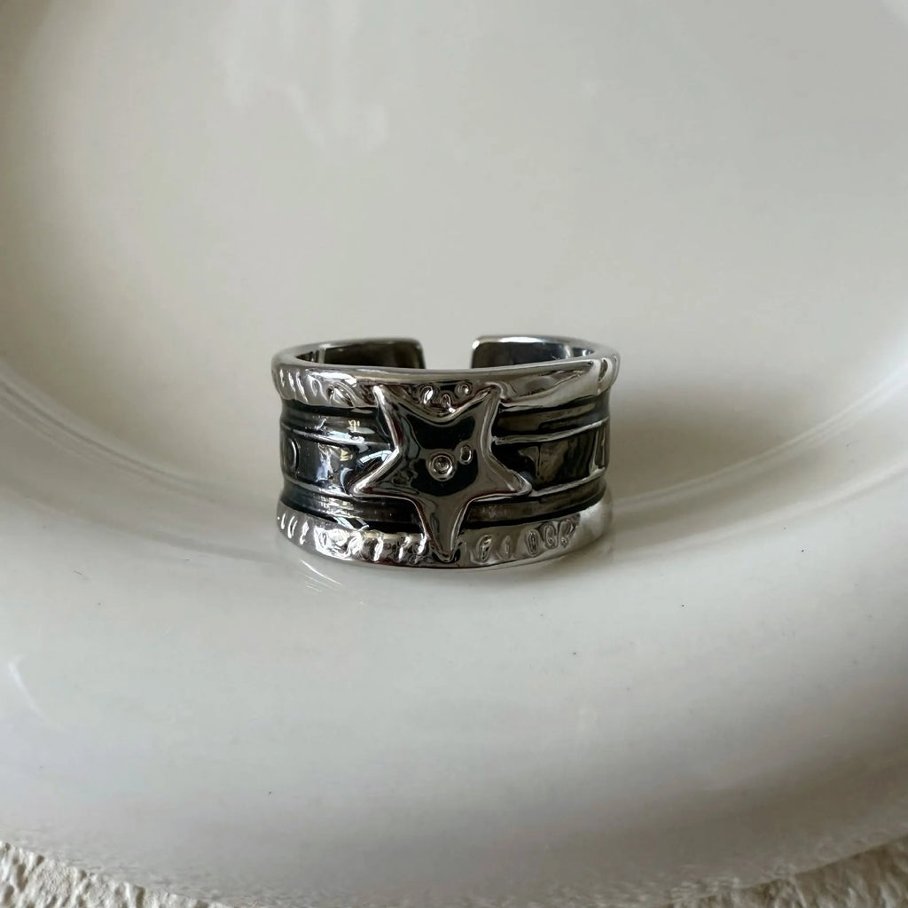 Geometric drop ring with distressed finish and adjustable band