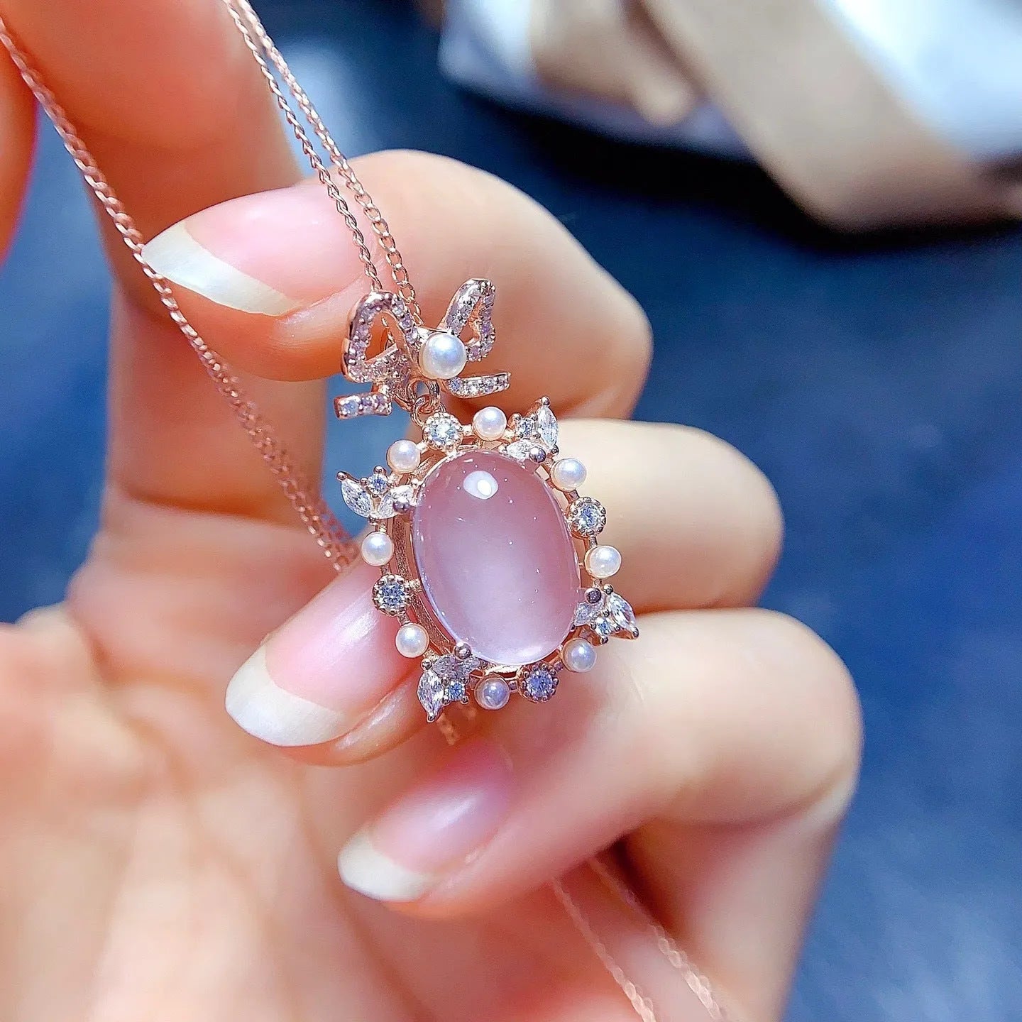 Geometric rose gold plated silver pendant with a natural pink rose quartz crystal on a chain.