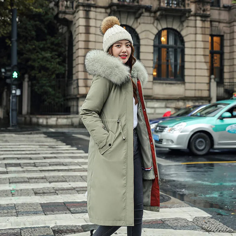 Women's long beige fleece trench coat with a belt, shown on a model.