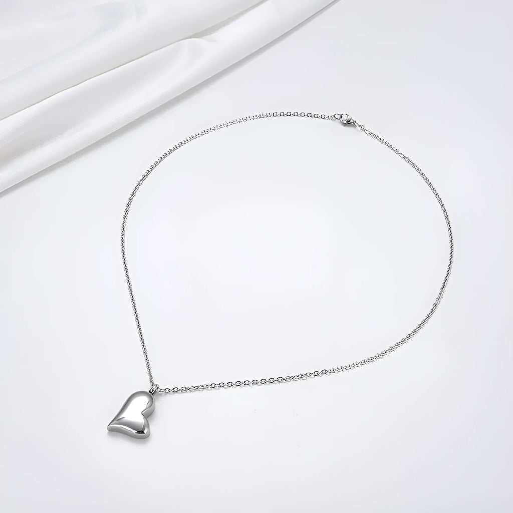 Silver stainless steel curved peach heart pendant necklace on a chain with extension