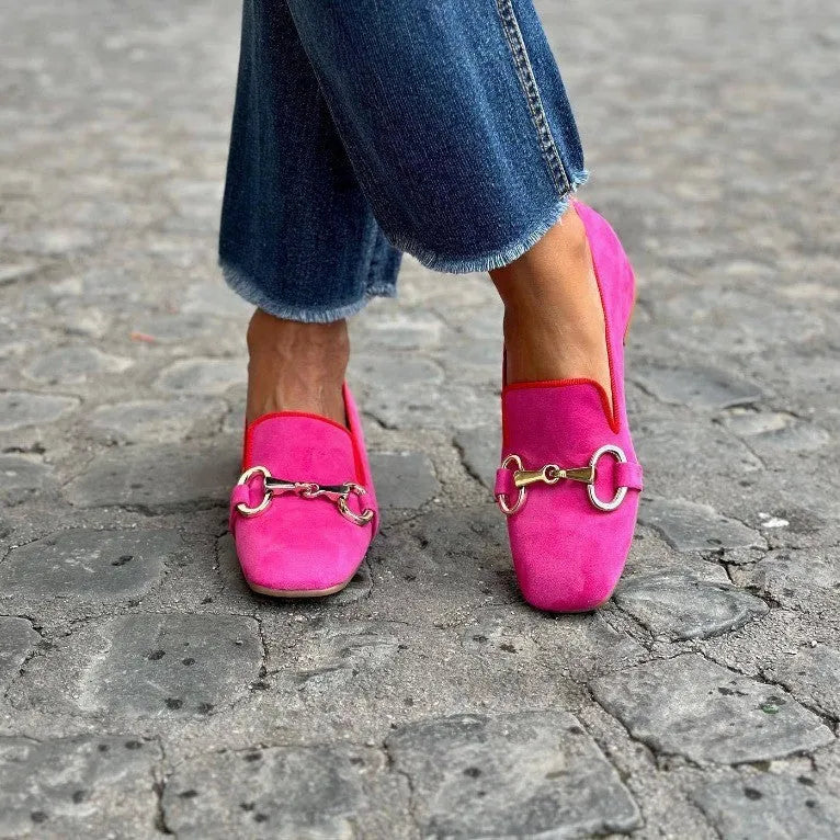 Green suede flat loafers with round toe, metal fastener, and a low rubber sole.