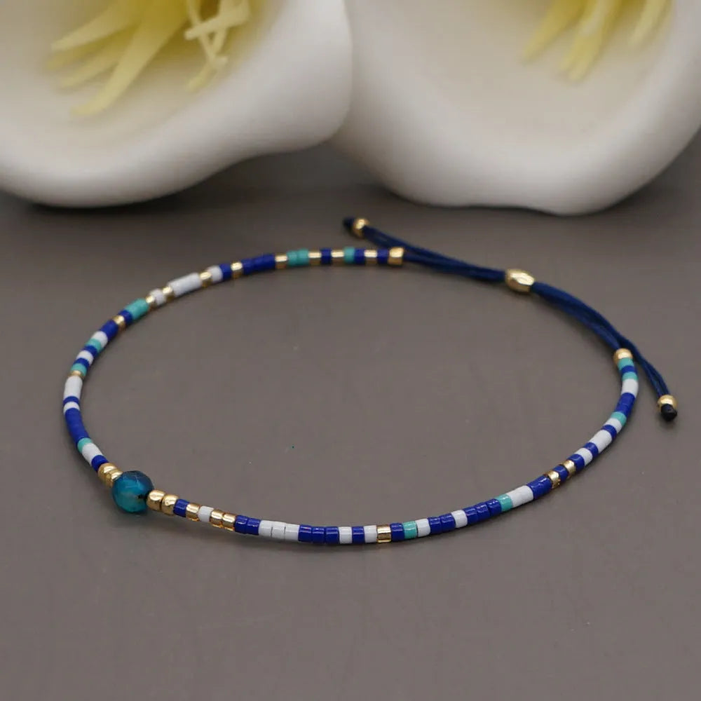 Women's handmade colourful beaded bracelet with geometric glass beads on adjustable cord