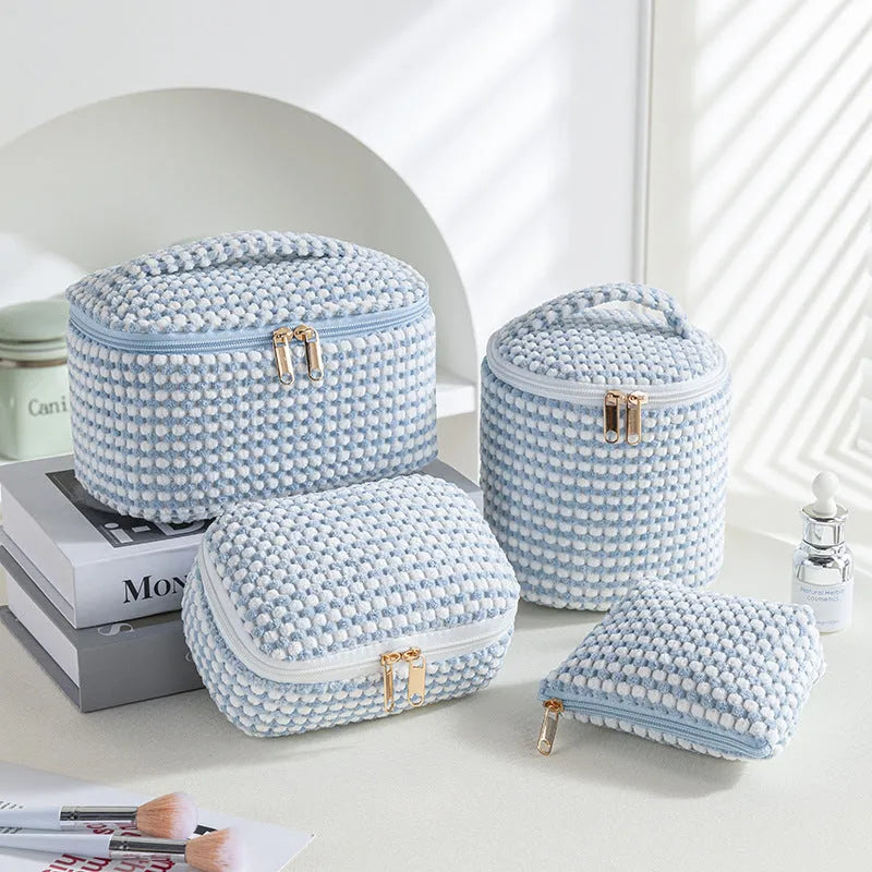 Four cube-style makeup bags in polyester material showing colour options: pink, khaki, pink dots, blue with dots