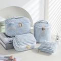 Four cube-style makeup bags in polyester material showing colour options: pink, khaki, pink dots, blue with dots