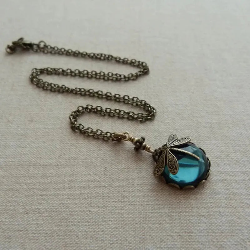 Vintage bronze hand carved dragonfly pendant on a silver chain, yellow colour