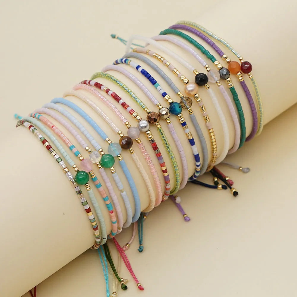 Women's handmade colourful beaded bracelet with geometric glass beads on adjustable cord