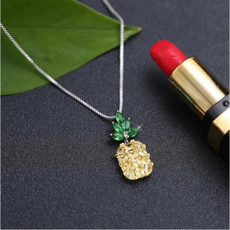 Silver pineapple charm necklace with geometric diamond design details