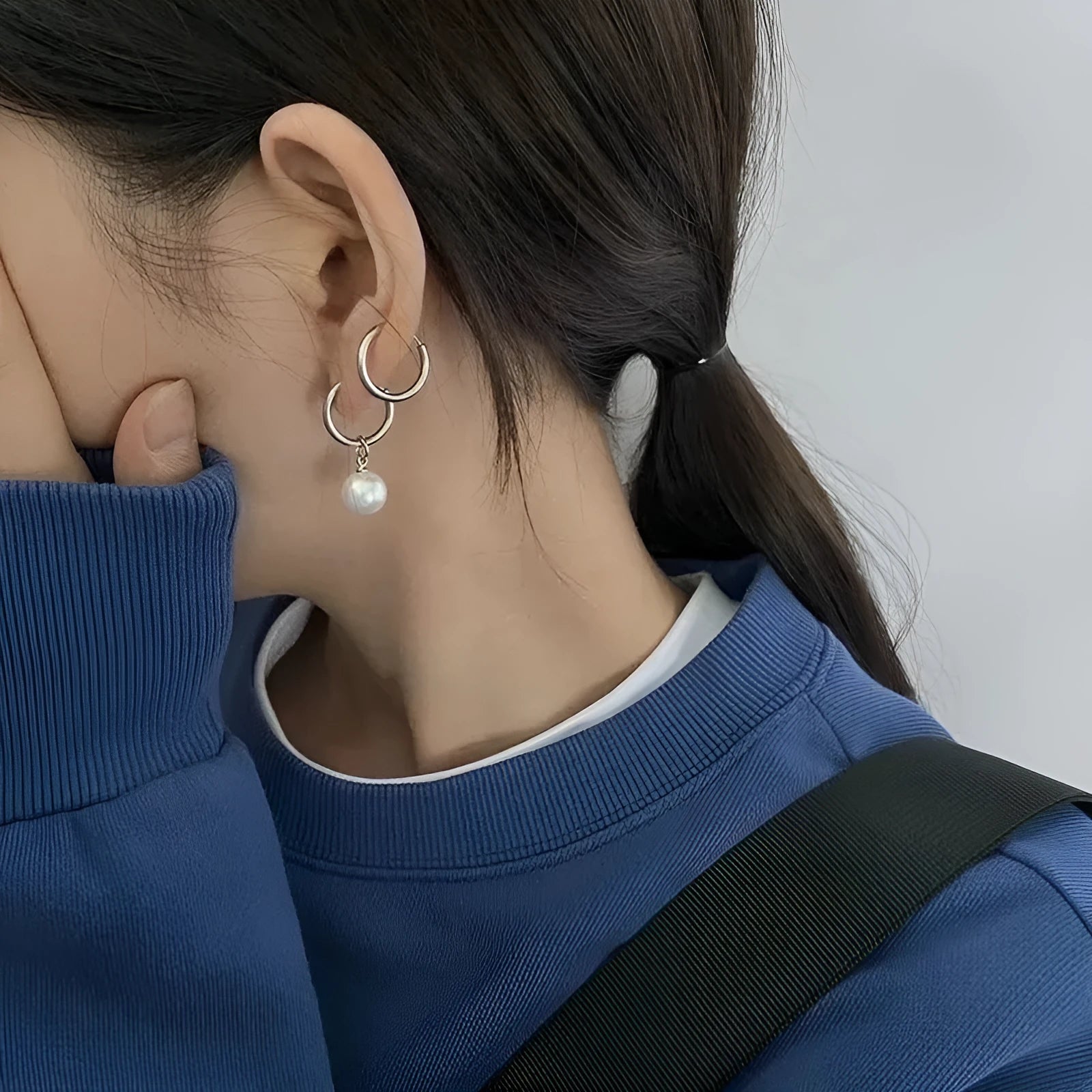 A pair of women's geometric alloy drop earrings with a round pearl centre and titanium steel post.