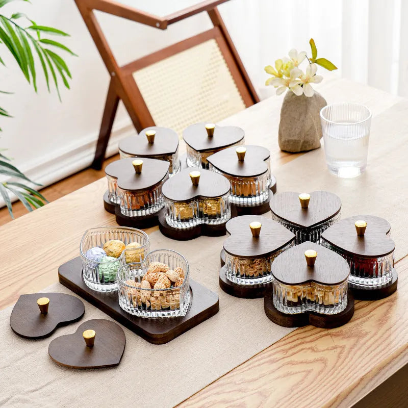 Glass retro-style snack platter with coloured glaze and a transparent heart-shaped lid over multiple compartments.