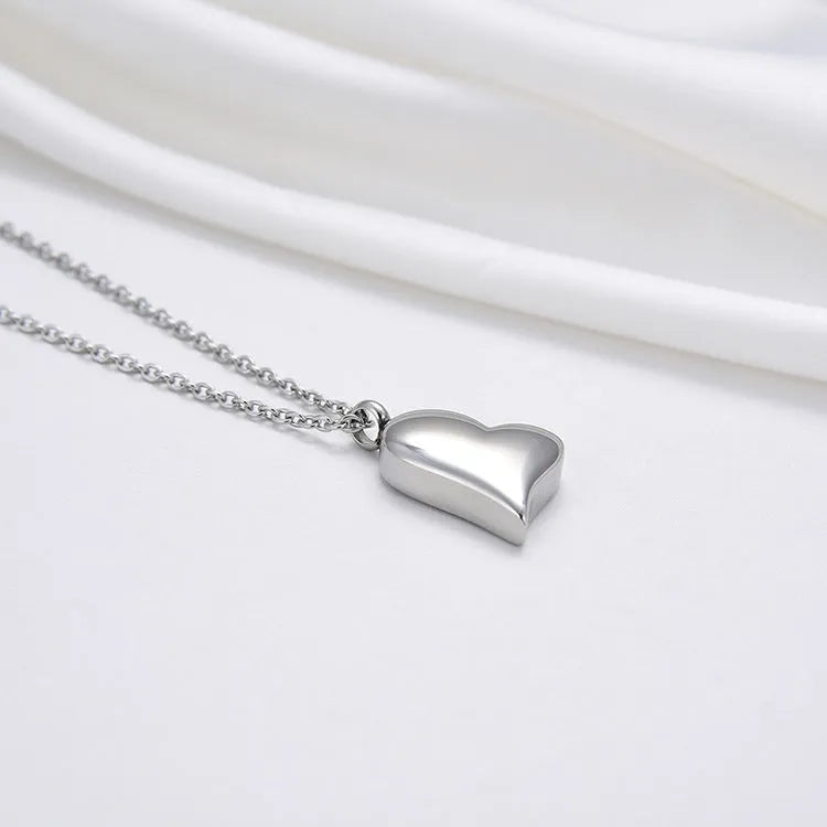 Silver stainless steel curved peach heart pendant necklace on a chain with extension