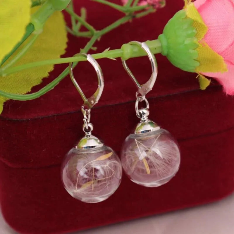 Transparent 16mm glass ball earrings with dandelion seed crystal design on silver French hooks