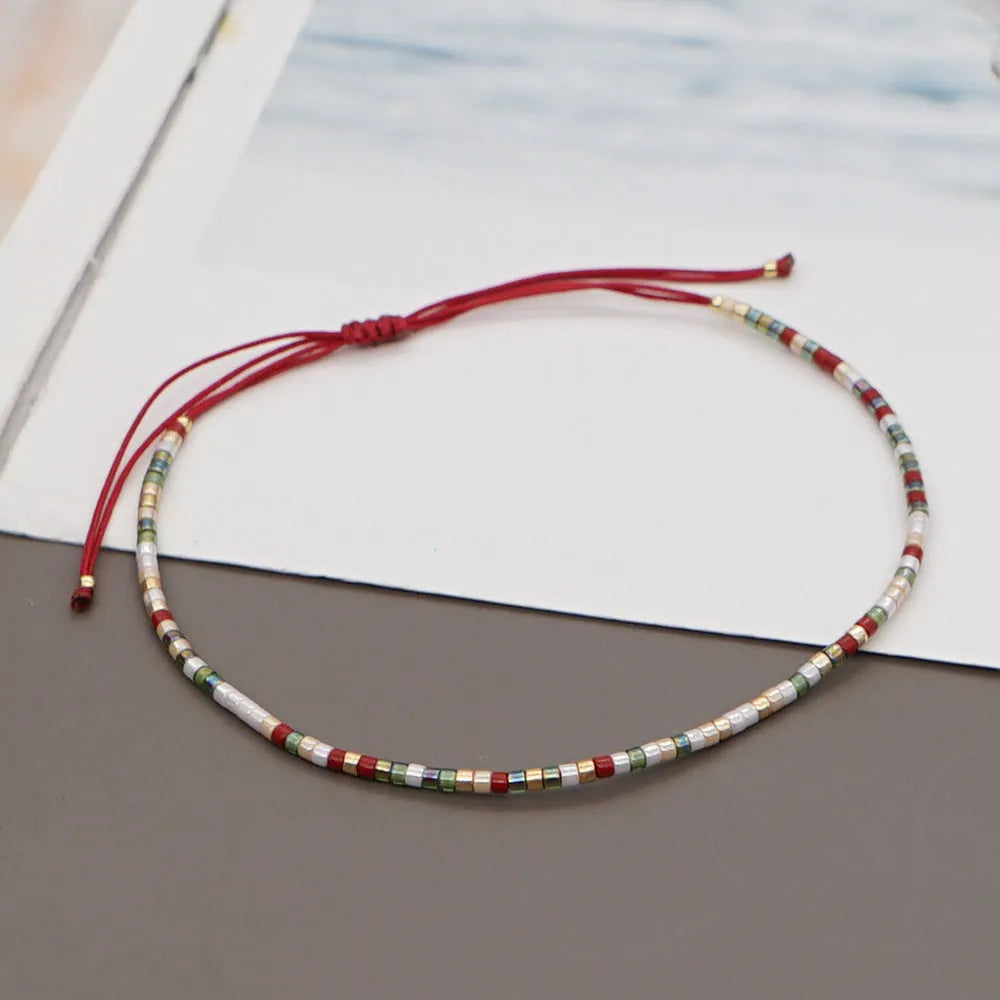 Women's handmade colourful beaded bracelet with geometric glass beads on adjustable cord