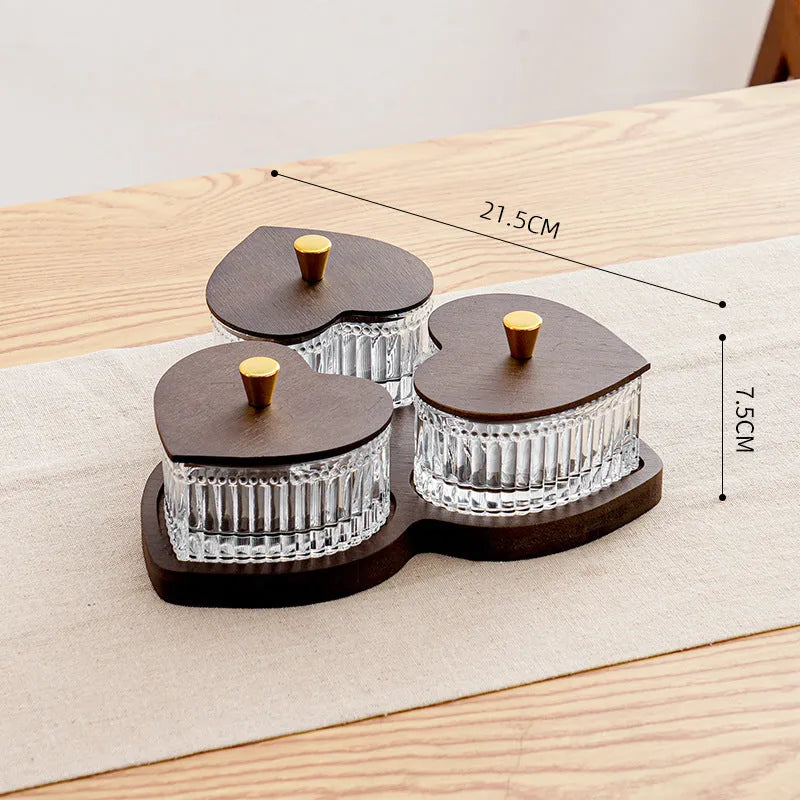 Glass retro-style snack platter with coloured glaze and a transparent heart-shaped lid over multiple compartments.