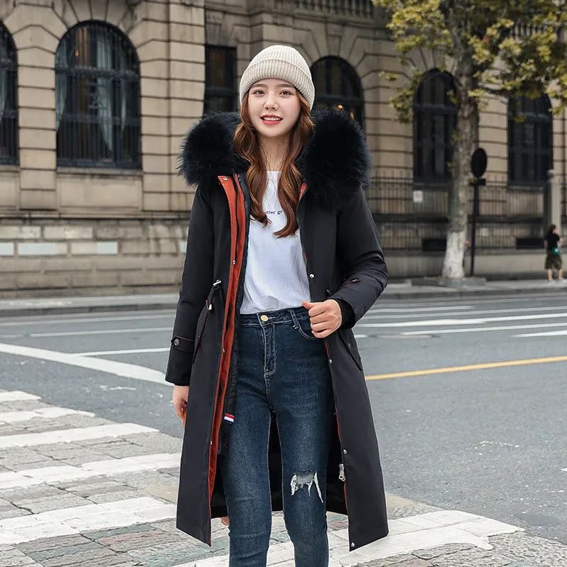 Women's long beige fleece trench coat with a belt, shown on a model.