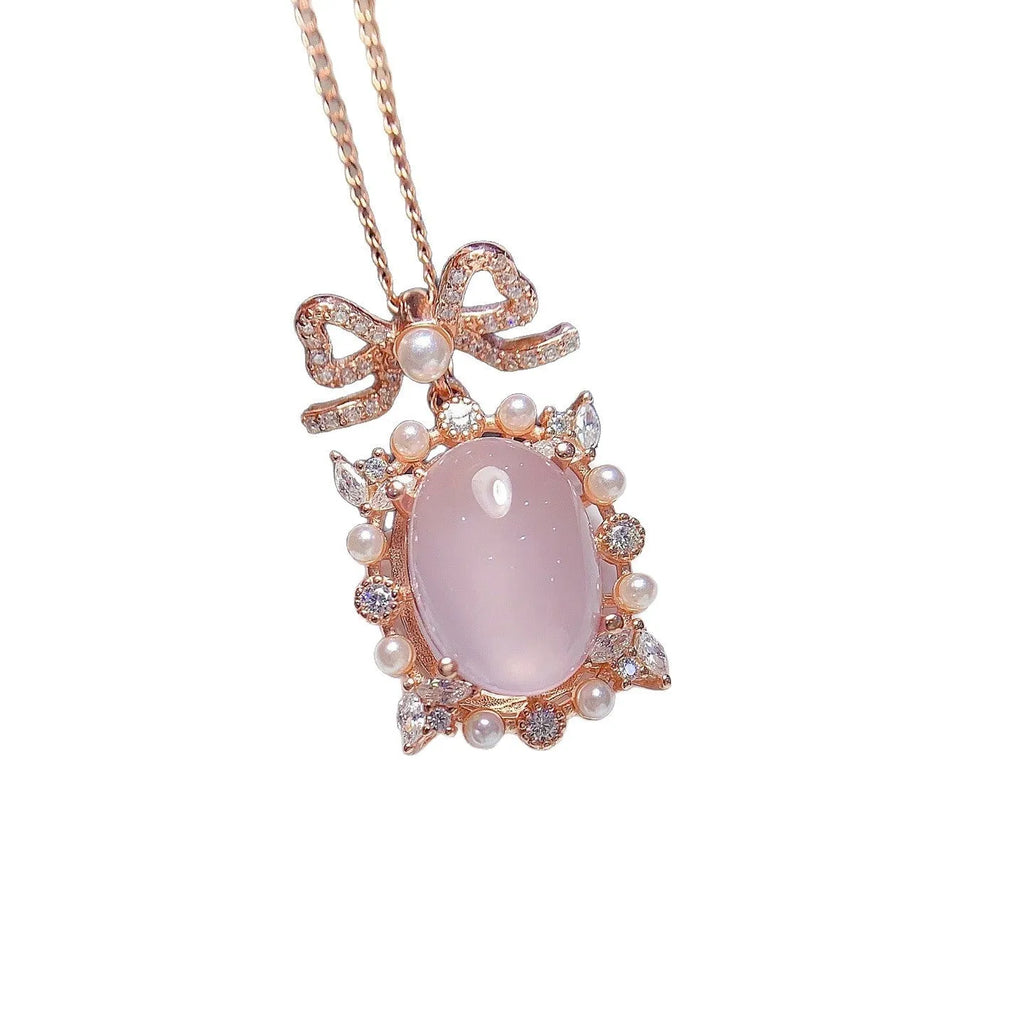 Geometric rose gold plated silver pendant with a natural pink rose quartz crystal on a chain.