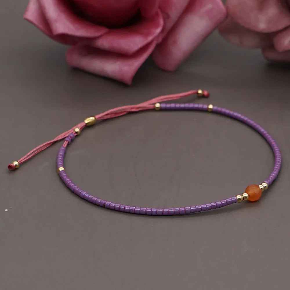 Women's handmade colourful beaded bracelet with geometric glass beads on adjustable cord