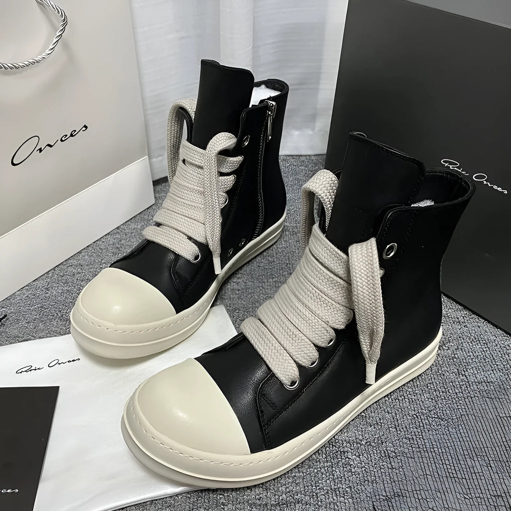 Black genuine leather high-top sneakers with side zipper and round toe on a rubber platform sole.