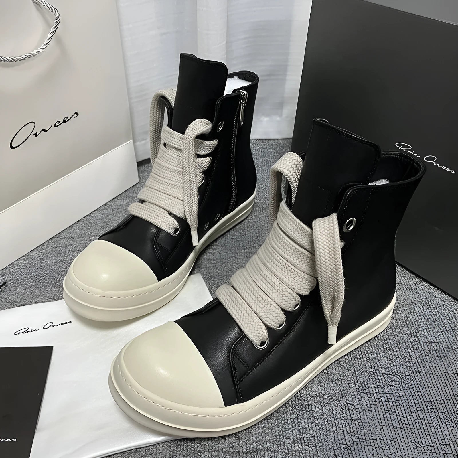 Black genuine leather high-top sneakers with side zipper and round toe on a rubber platform sole.
