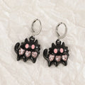 Women's alloy cross crystal earrings in five designs: white cross, peach heart, black cat, antique silver star.
