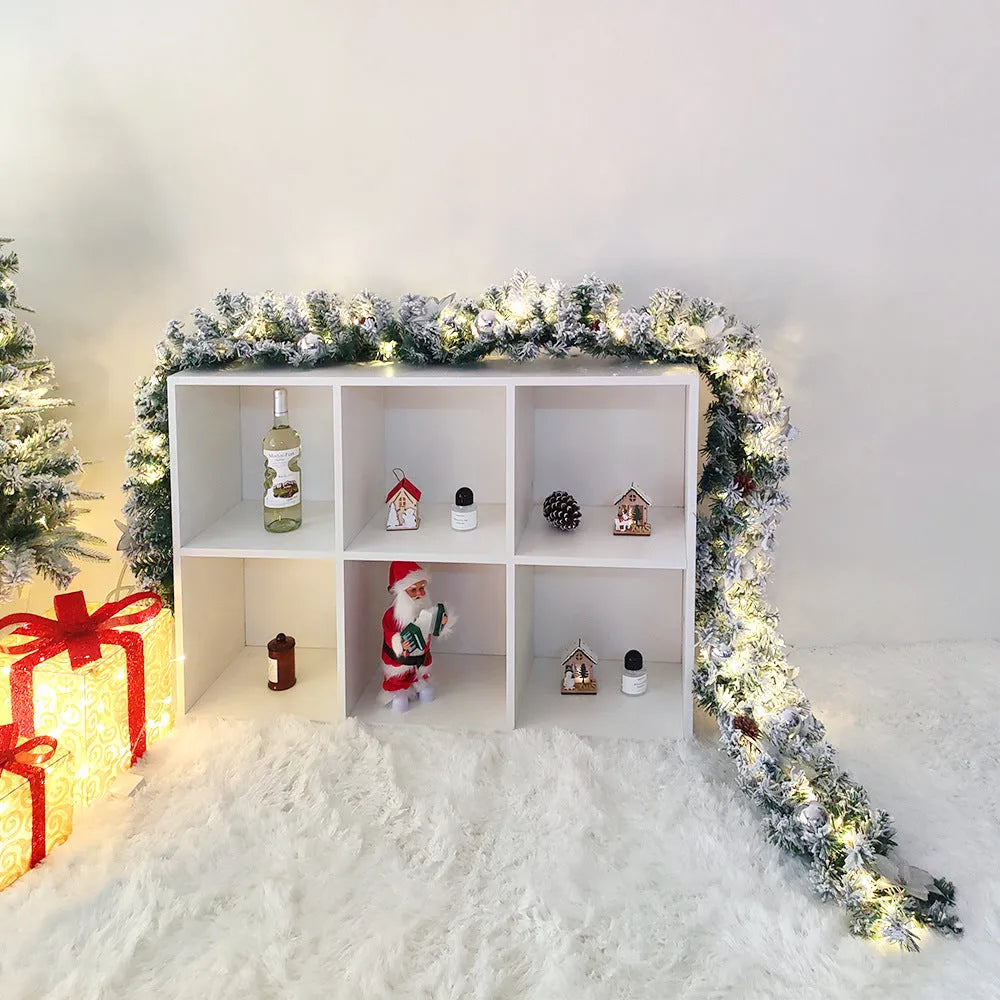 PVC Christmas rattan garland with flocking in golden colour, draped decoratively.